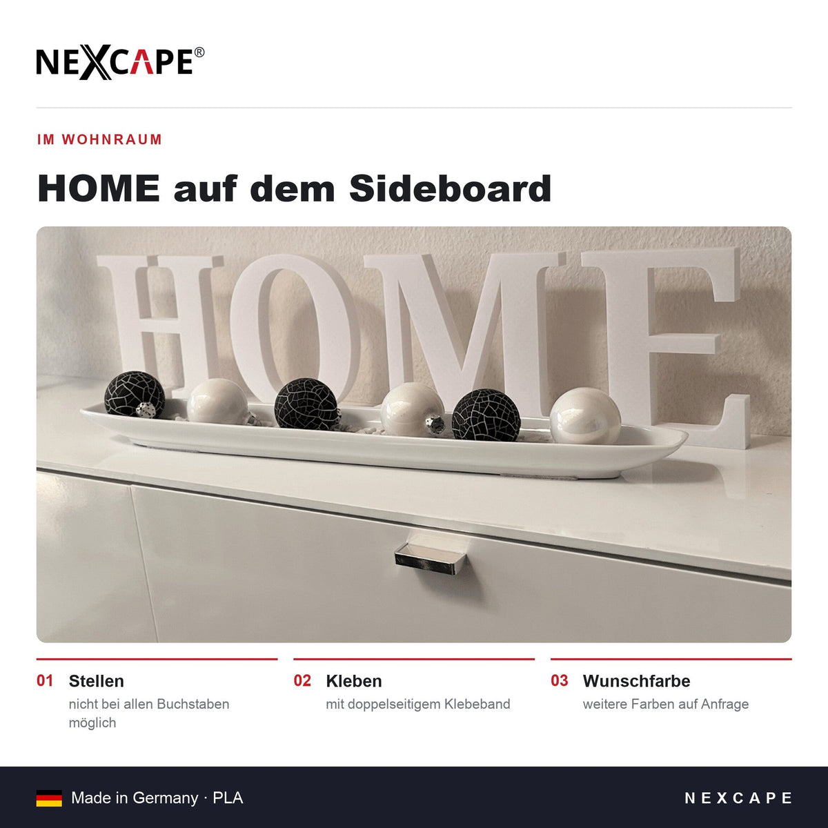 Weiße 3D-Buchstaben als Schriftzug HOME auf einem weißen Sideboard