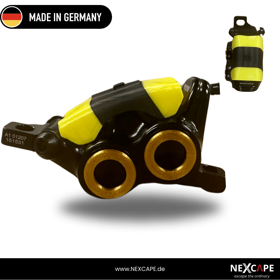 NEXCAPE Schmutzfänger (Mud Cover) in Gelb auf dem Magura MT5/MT7 Bremssattel montiert – Bremssattel-Schutzblende gegen Schmutz fürs MTB/E-Bike, Made in Germany